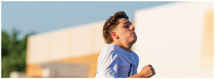 A football player wearing a blue and white uniform. Description generated by AI