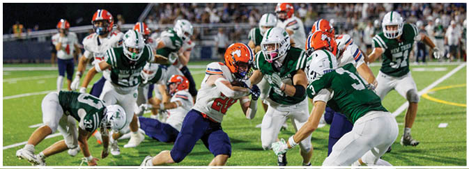 A group of football players on a field. Description generated by AI