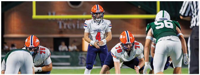 A football player is sliding on the ground. Description generated by AI