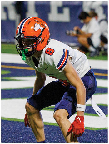 A football player wearing a blue jersey with the number 58 on it. Description generated by AI