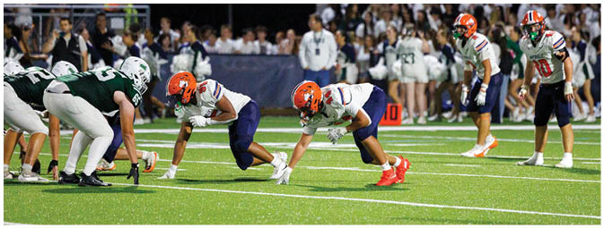 A football player is sliding on the ground. Description generated by AI