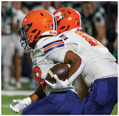 A football player running on the field. Description generated by AI
