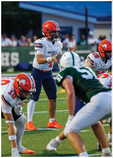 A football player wearing a blue jersey with the number 58 on it. Description generated by AI