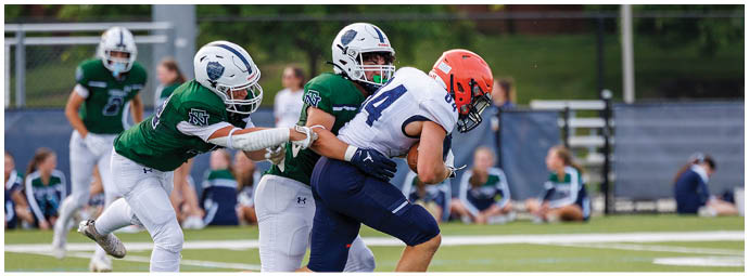 A football player wearing a blue and white uniform. Description generated by AI