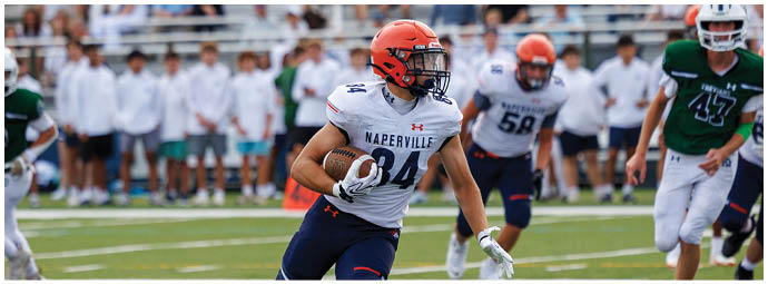 A football player wearing a blue and white uniform. Description generated by AI