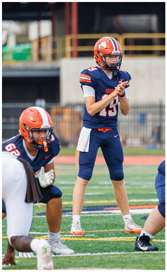 A football player catching a ball. Description generated by AI