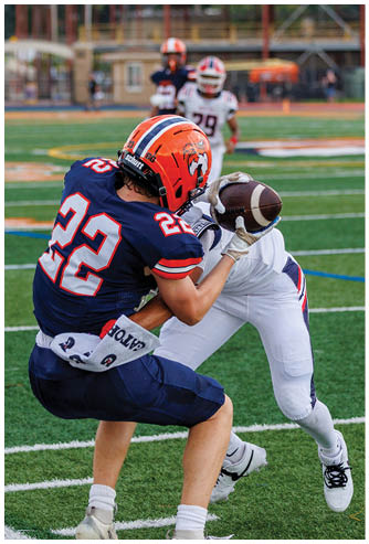 A football game is being played on a field. Description generated by AI