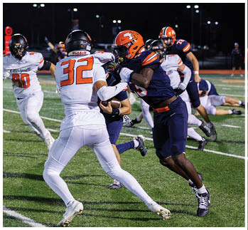 A football player running on the field. Description generated by AI