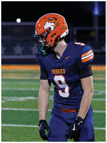 A football player wearing a blue jersey with the number 58 on it. Description generated by AI