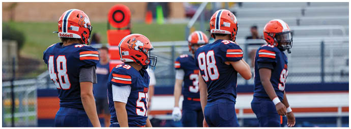 A football player wearing a blue and white uniform. Description generated by AI