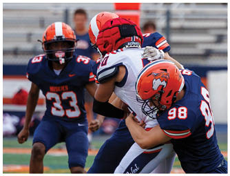 A group of football players on a field. Description generated by AI