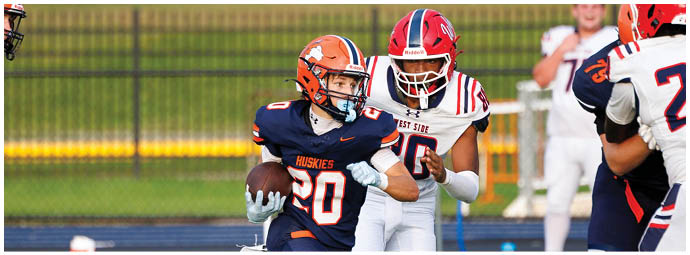 A football player wearing a blue and white uniform. Description generated by AI