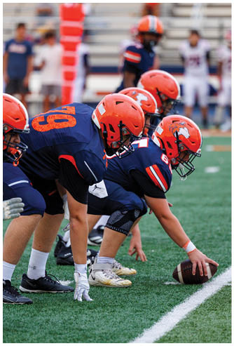 A football game is being played on a field. Description generated by AI