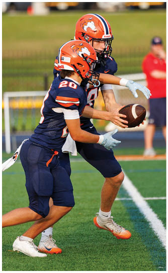 A football player catching a ball. Description generated by AI