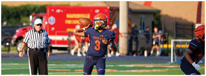 A football player wearing a blue and white uniform. Description generated by AI