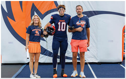 A group of football players wearing black and white uniforms. Description generated by AI