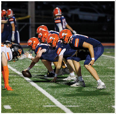A football player running on the field. Description generated by AI