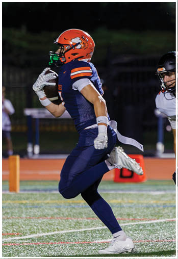 A football player running on the field. Description generated by AI