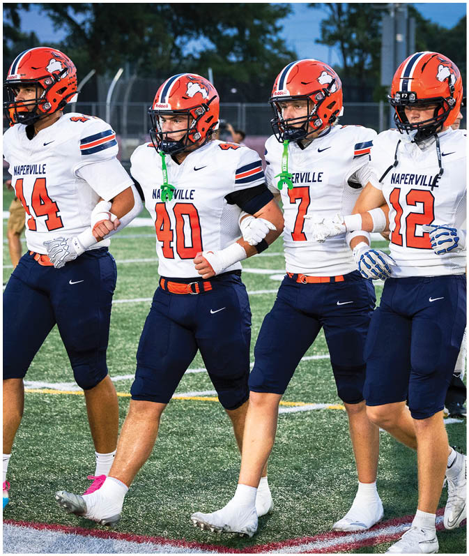 A group of football players wearing black and white uniforms. Description generated by AI