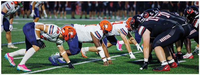 A football player is sliding on the ground. Description generated by AI