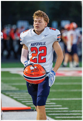 A football player running on the field. Description generated by AI