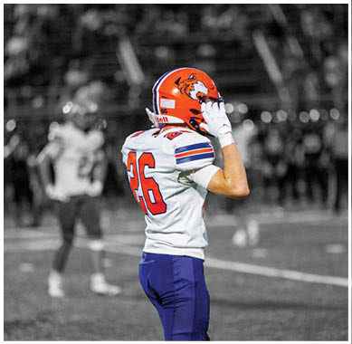 A football player running on the field. Description generated by AI