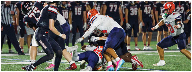 A football player is sliding on the ground. Description generated by AI