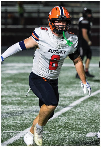 A football player running on the field. Description generated by AI