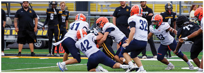 A group of football players on a field. Description generated by AI
