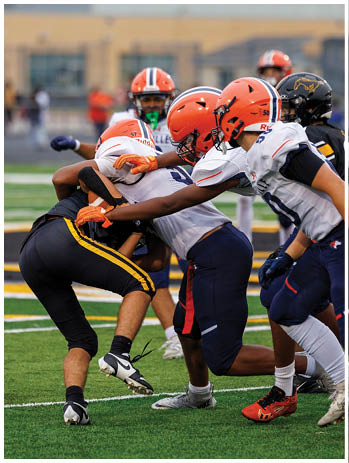 A football player wearing a blue jersey with the number 58 on it. Description generated by AI