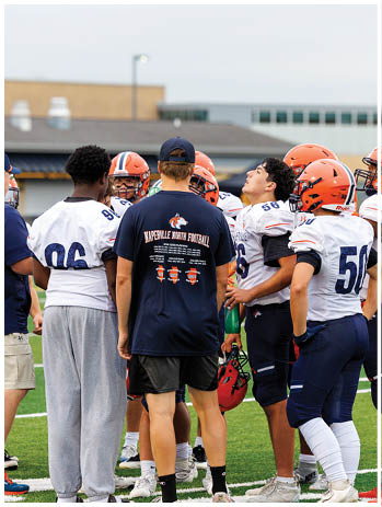 A football player wearing a blue jersey with the number 58 on it. Description generated by AI