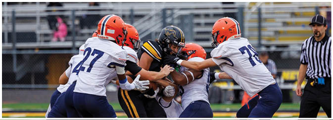 A group of football players on a field. Description generated by AI