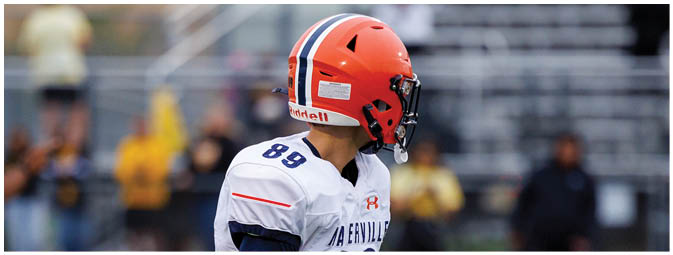 A football player is sliding on the ground. Description generated by AI