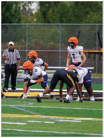 A football player wearing a blue jersey with the number 58 on it. Description generated by AI