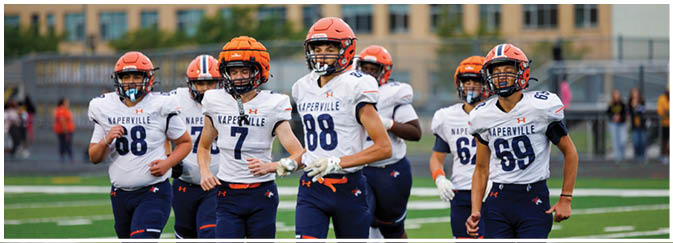 A group of football players on a field. Description generated by AI
