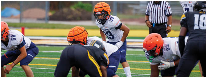 A football player is sliding on the ground. Description generated by AI