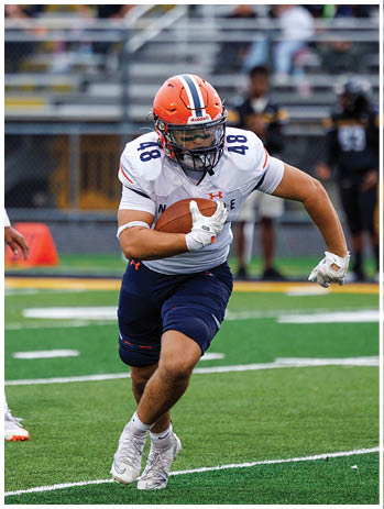 A football player wearing a blue jersey with the number 58 on it. Description generated by AI