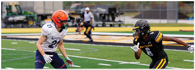 A group of football players on a field. Description generated by AI