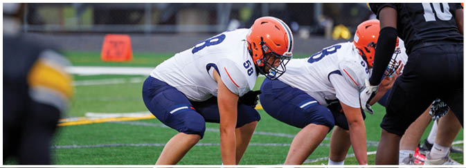 A group of football players on a field. Description generated by AI
