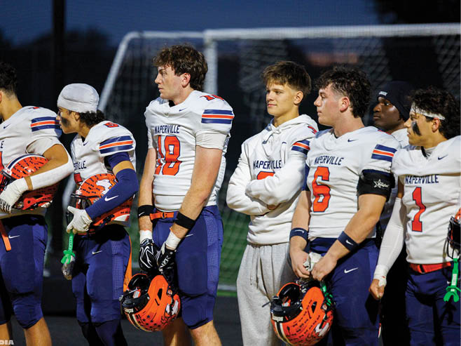 A group of football players in black and white uniforms are on the field. AI generated content