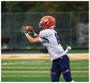 A football player running on the field. Description generated by AI