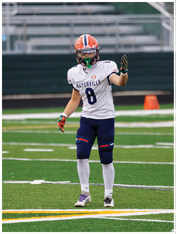 A football player wearing a blue jersey with the number 58 on it. Description generated by AI