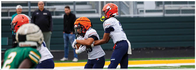 A group of football players on a field. Description generated by AI