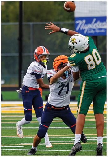 A football player running on the field. Description generated by AI