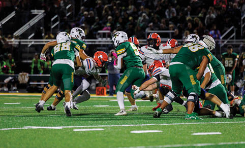 Two men wearing football uniforms are hugging each other on a field. AI generated content