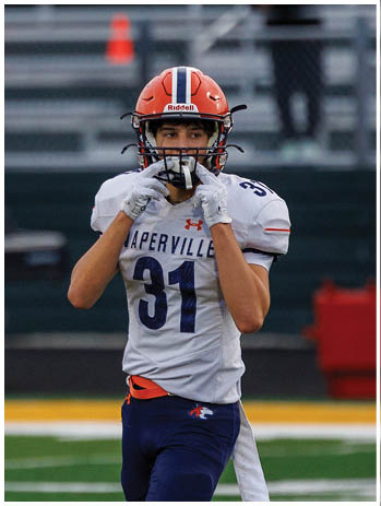 A football player wearing a blue jersey with the number 58 on it. Description generated by AI