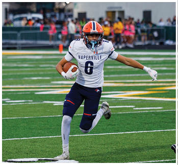 A football player running on the field. Description generated by AI