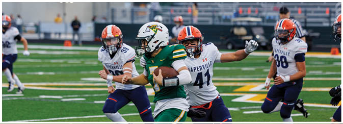 A group of football players on a field. Description generated by AI
