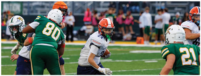 A football player is sliding on the ground. Description generated by AI