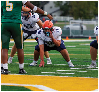 A football player running on the field. Description generated by AI